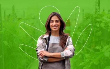 mujer cruzada de brazos, sonriendo con fondo verde
